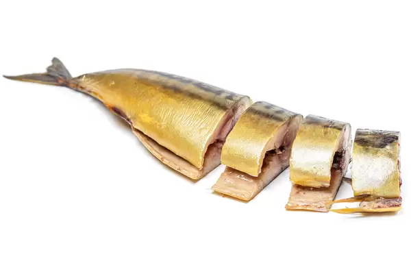 Smoked mackerel fish cut into pieces on white background