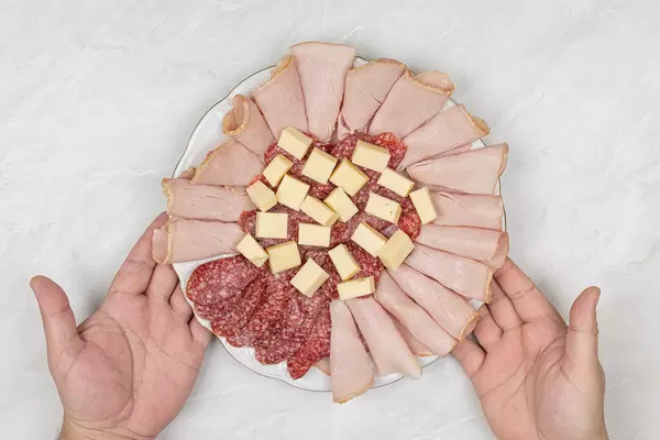 Smoked Meat and Sausages served with Cheese on the plate