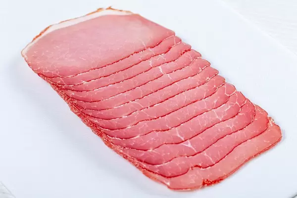 Smoked pork ham sliced on the slicer (Flip 2019)