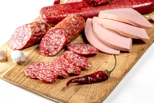 Smoked salami and sausage sliced on a wooden kitchen Board, close up (Flip 2020)