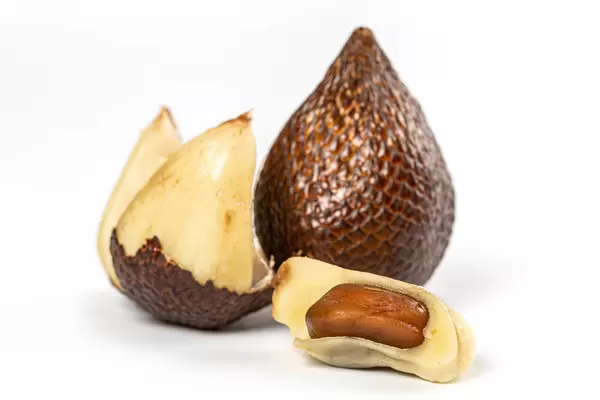 Snake fruit whole and peeled skin on white background