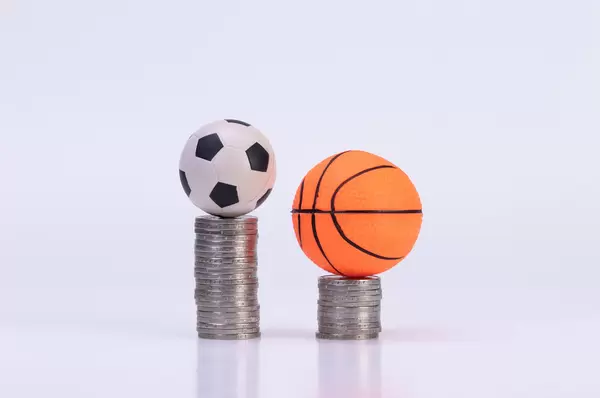 Soccer ball and basketball ball on coinstacks