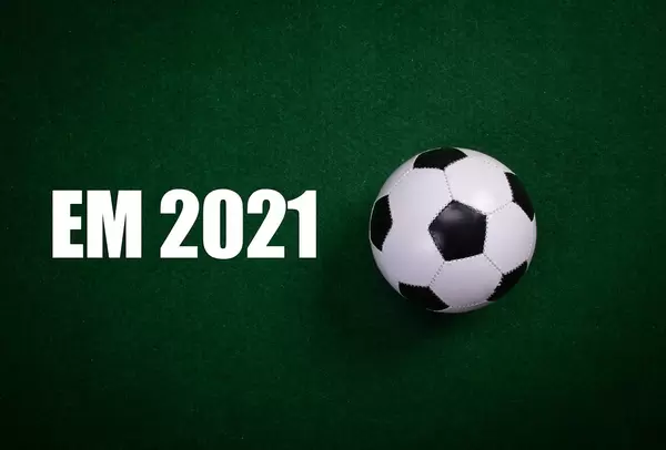 Soccer ball and EM 2021 text on green grass