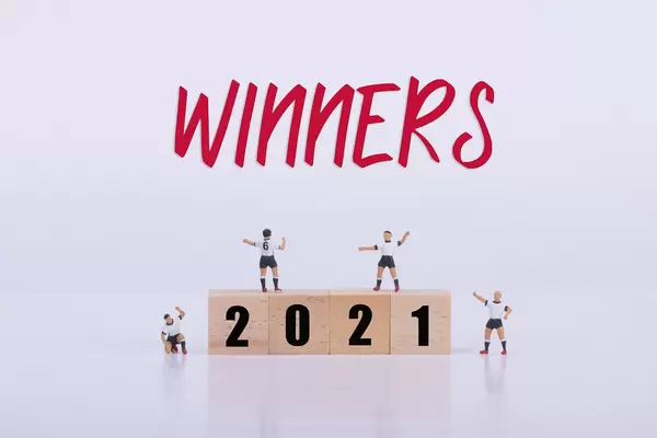 Soccer players standing on wooden cubes with 2021 text and Winners text