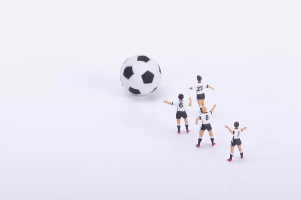 Soccer players with soccer ball on white
