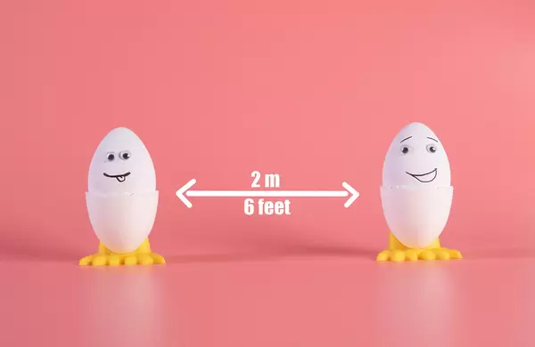 Social distancing concept with cute Easter eggs