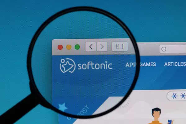 Softonic logo under magnifying glass
