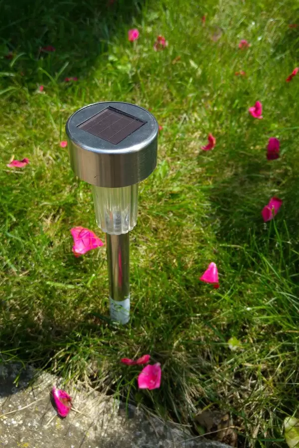 Solar garden light with rose petals all around