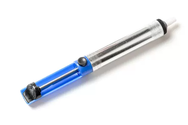Solder sucker or desoldering pump for soldering on white background