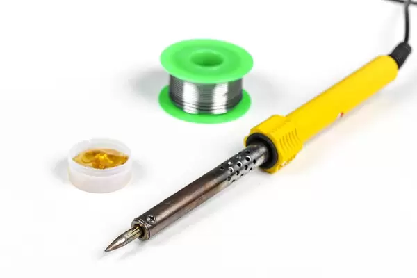 Soldering iron, tin and rosin on a white background