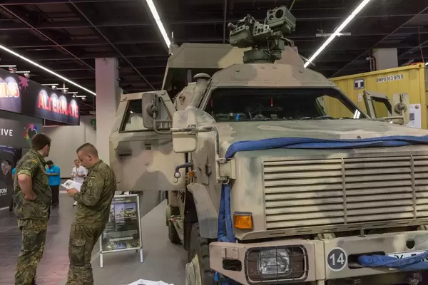 Soldiers standing next to a Dingo 2 GSI military all-terrain vehicle