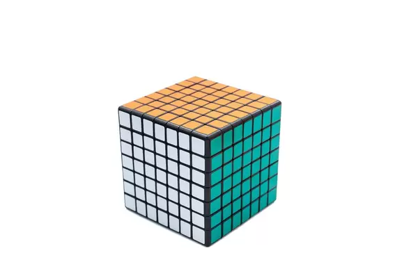 Solved Rubik's cube 7x7x7 on white background with green, white and orange sides (Flip 2019)