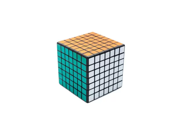 Solved Rubik's cube 7x7x7 on white background with green, white and orange sides
