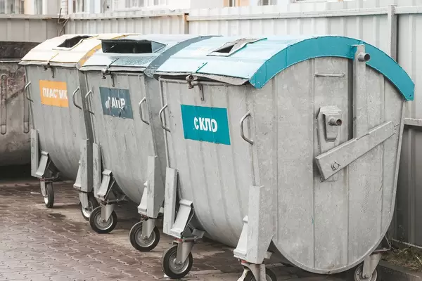 Sorting garbage into different waste bins for recycling