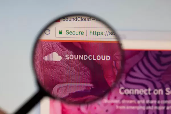 Soundcloud logo on a computer screen with a magnifying glass