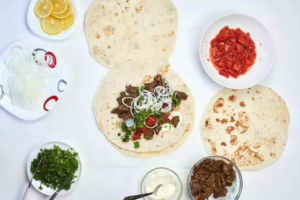 South Caucasus cuisine. Overhead view of Lavash flat bread with tasty ingredients to fill