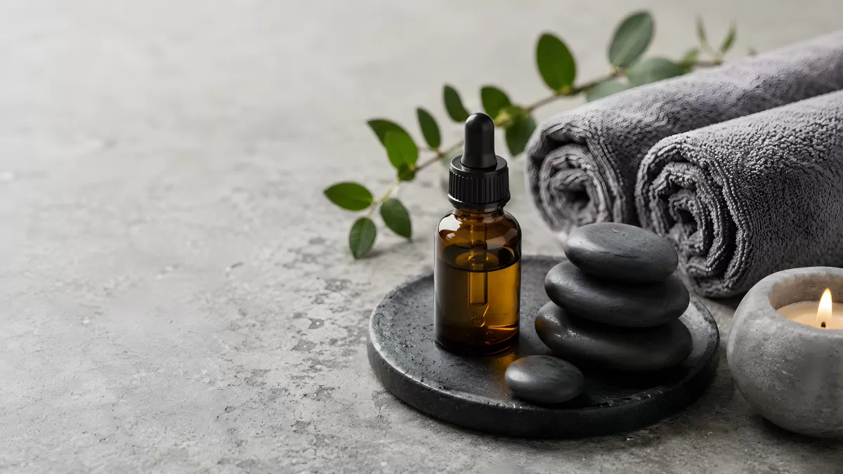 Spa-Stillleben mit Öl, Basaltsteinen und Handtüchern