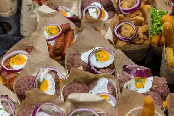 Spanish food stand sells Burritos filled with Chorizo sausages, meatballs, chips, eggs & calamares-merluza fish mix at Mercat de la Boqueria, Barcelona