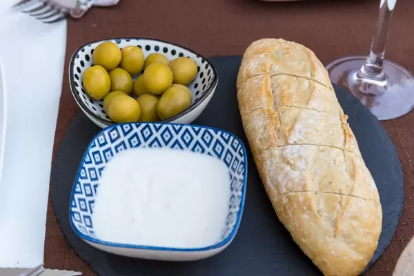 Spanish tapas: bread with aioli and olives at Q11 restaurant in Pollença, Mallorca