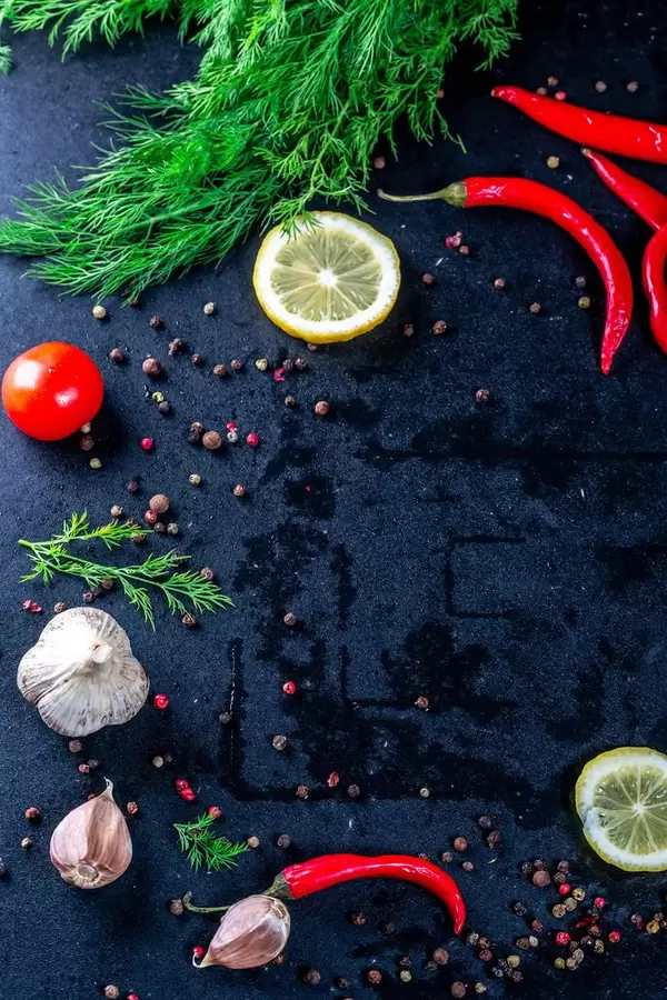 Spices and fresh dill on black background