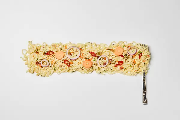 Spicy instant noodles on fork