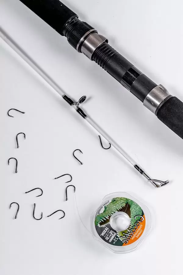 Spinning, hooks and fishing line on white background (Flip 2019)