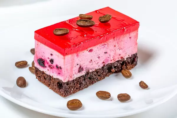 Sponge cream cake with red marmalade and coffee grains