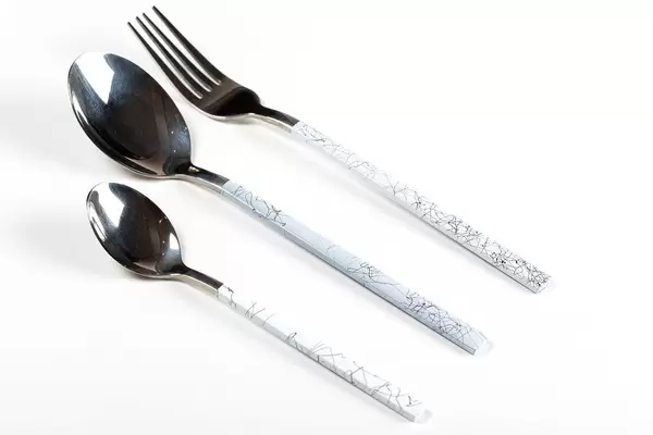 Spoon, fork and teaspoon on white background