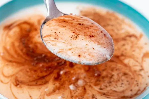 Spoon with cottage cheese, yogurt and cocoa, close -up (Flip 2020)