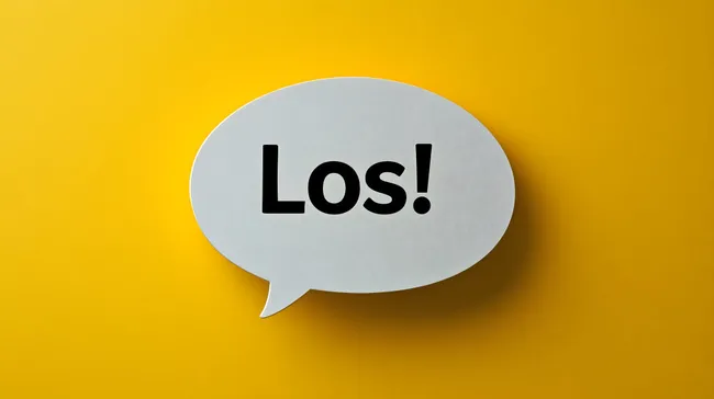 Sprechblase mit deutlichem Schriftzug 'Los!' auf gelbem Hintergrund