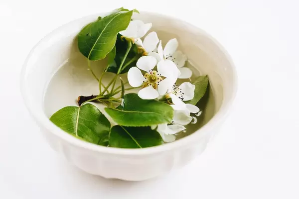 Spring flowers in a cup with water. Table decoration