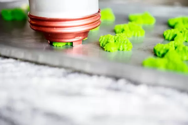 Spritz cookie press in a baking sheet
