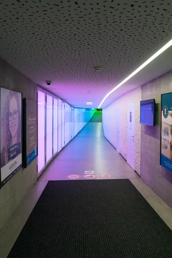 Square passage to shopping center with vivid purple gradient lighting