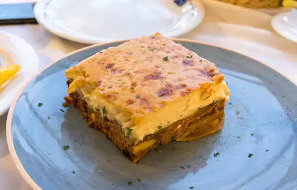 Square piece of lasagna on a blue plate