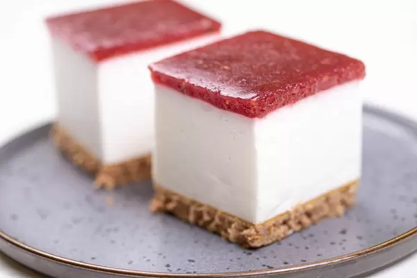 Square slice of Cheese Cake served on the plate