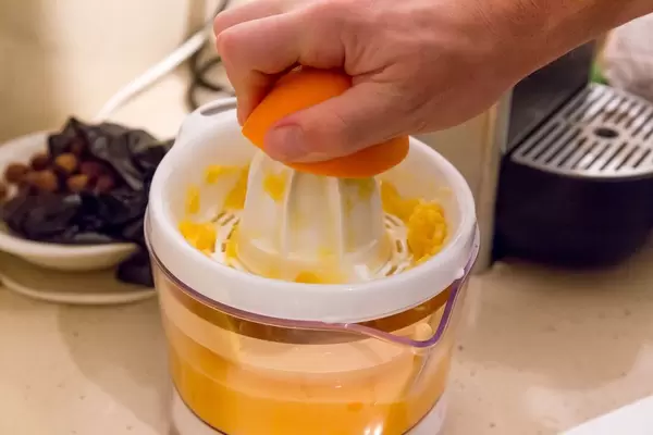 Squeezeing out orange juice early in the morning