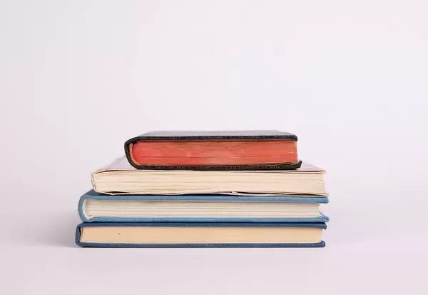 Stack of books on white background
