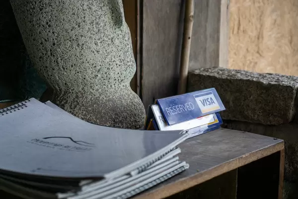 Stack of Food and Drink Menus and Reserved Table Signs on a Wooden Table in a Restaurant