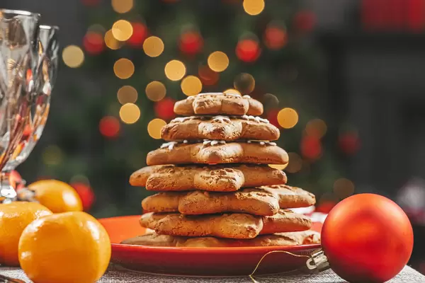 Stack of gingerbread in a red plate on a new year's background bokeh