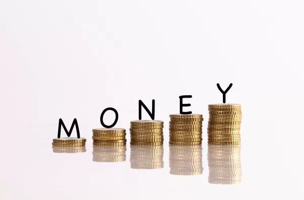 Stack of gold coins with arrow and money text