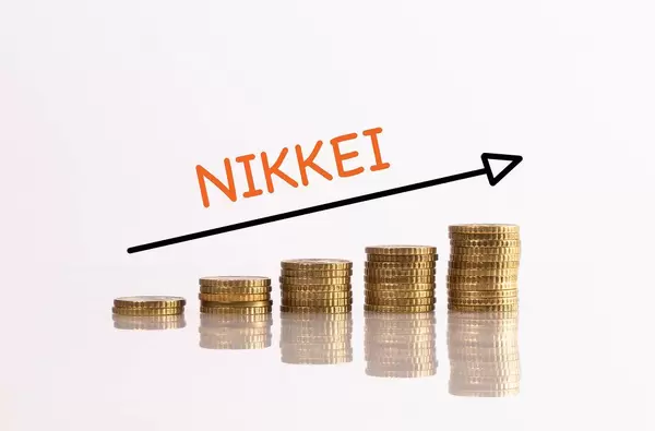 Stack of gold coins with arrow and NIKKEI text