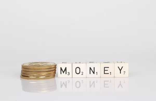 Stack of golden coins with money text