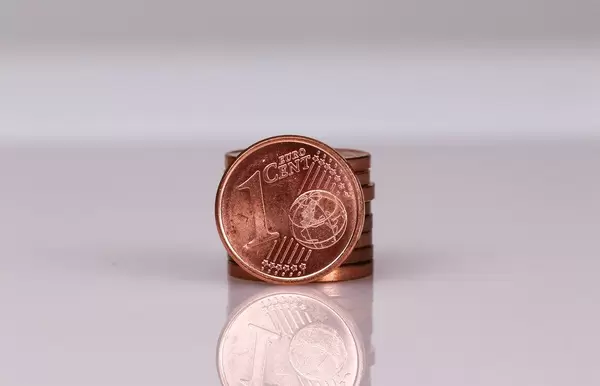 Stack of One Euro cent coins on white background