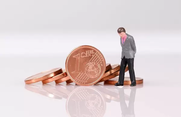 Stack of One Euro cent coins with businessman on white background