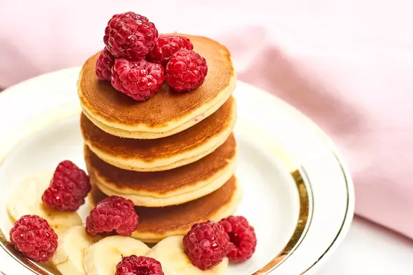 Stack of pancakes with berries on a plate