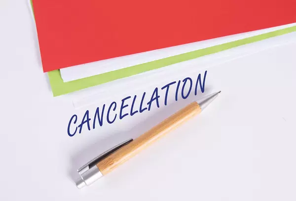 Stack of papers with pen and Cancellation text