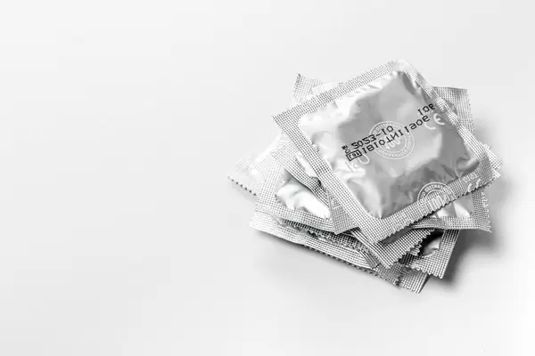 Stack of sealed condoms on a white background (Flip 2019)