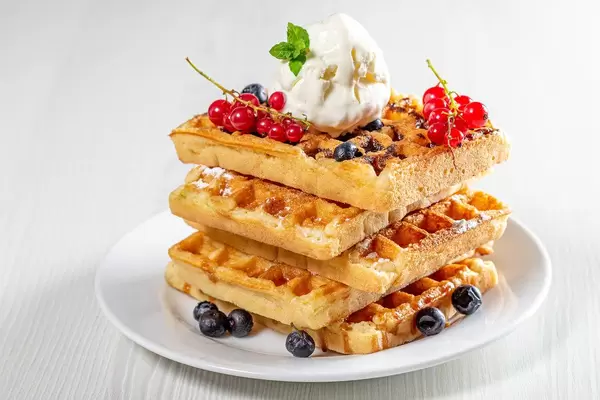Stack of waffles with fresh berries and ice cream (Flip 2019)