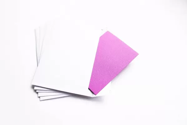 Stack of white envelopes with purple card on white background