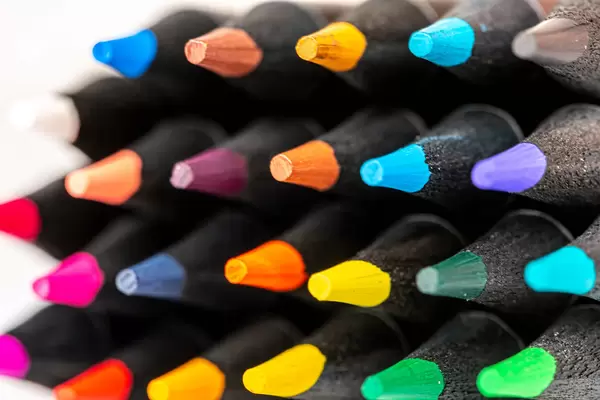 Stacked color pencils close up shot showing sharp pencil tips